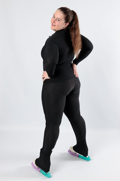 The Belgium Championship leggings as seen on an adult skater. The leggings are black and come down over the heel of the skate.